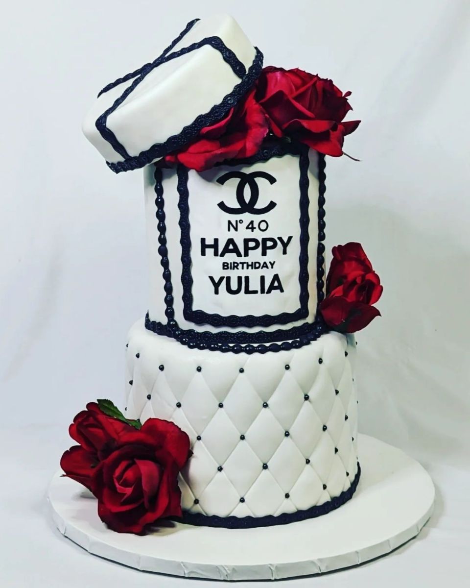 Chanel black and white cake with red roses